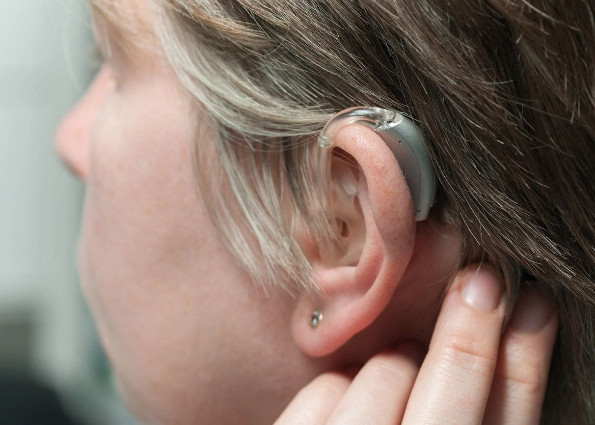 A person with their ear buds in the ear.